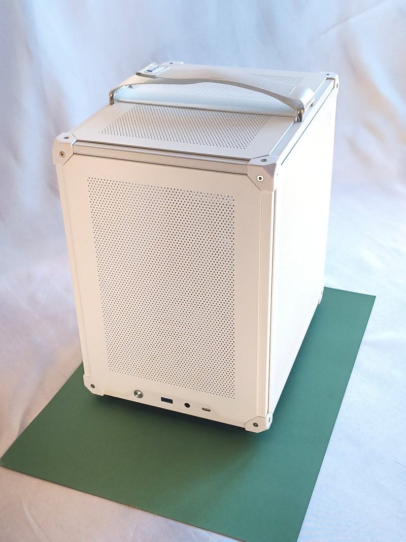Jonsbo C6 ITX on top of cardboard A3 format